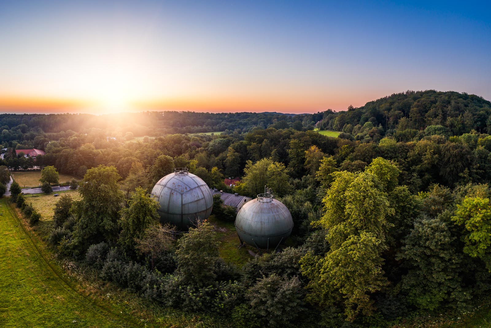 Sunrise above the old gasometers in the Teutoburg Forest (Bielefeld-Bethel, Germany).