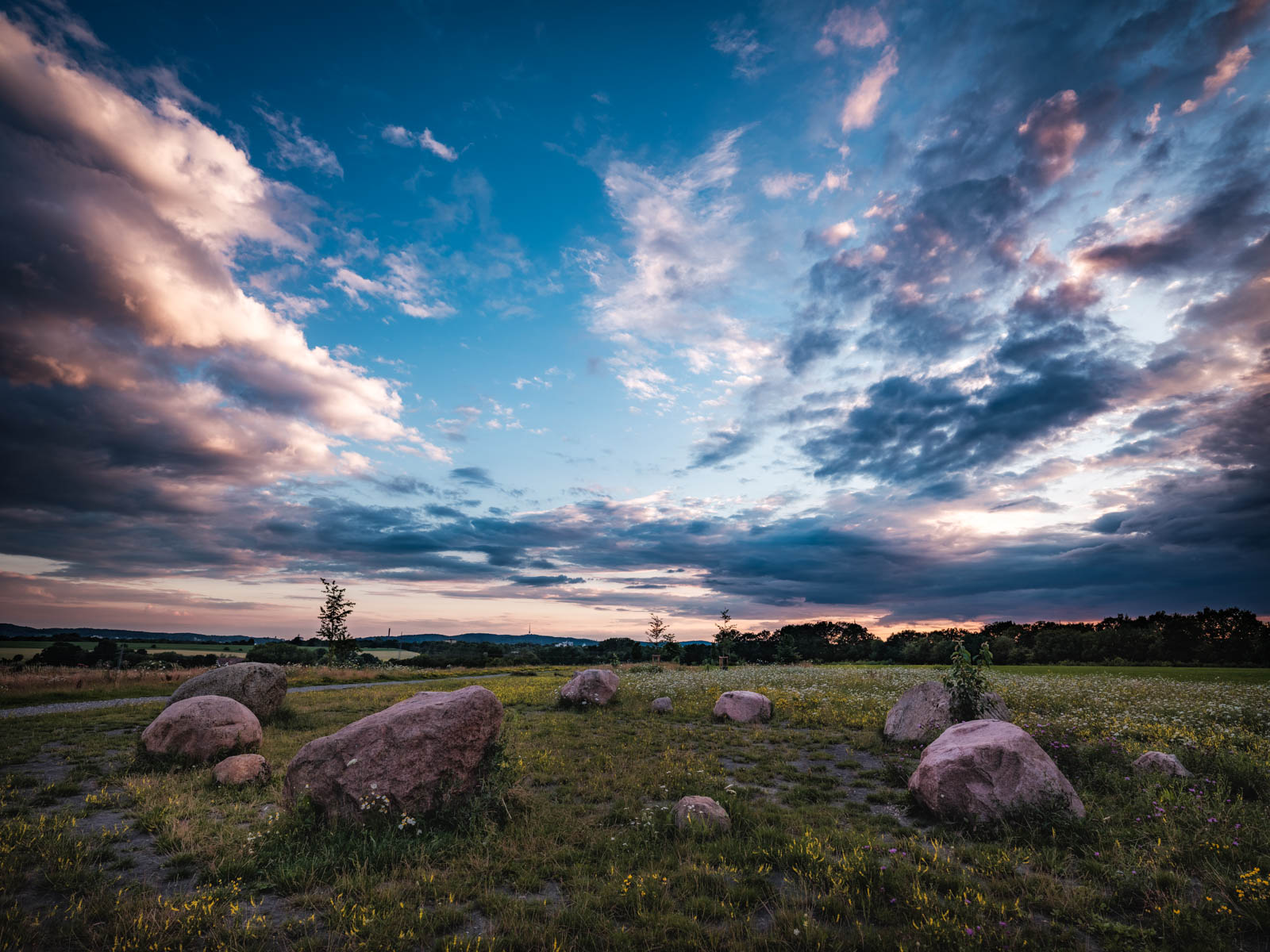 Landscape with erratic rocks at dusk in July 2020 (Bielefeld, Germany).