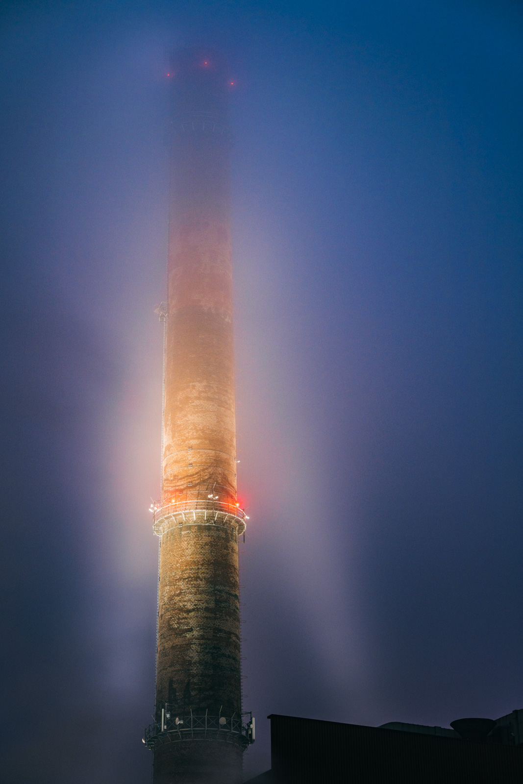 Chimney in the morning fog (Bielefeld, Germany).