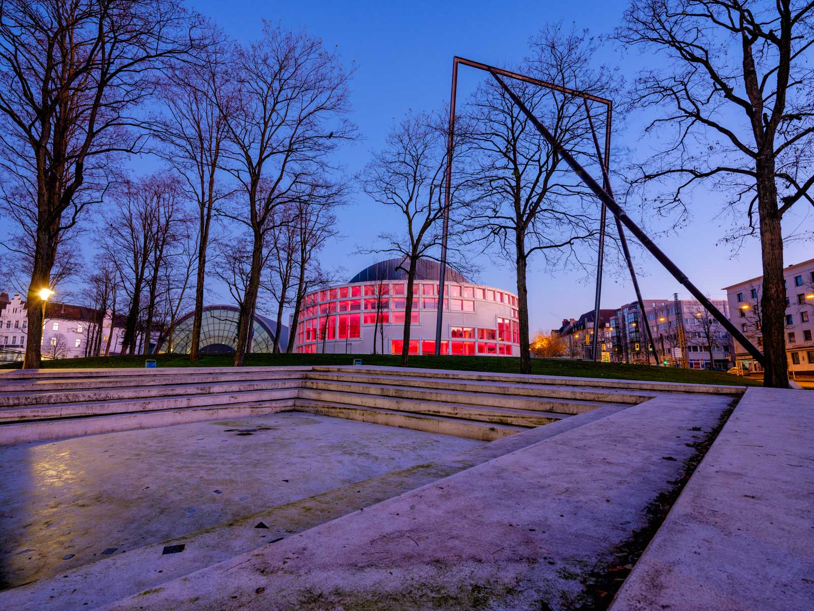 Conference hall (Stadthalle) and - from the end of December 2020, the COVID 19 Pandemic Vaccination Centre - illuminated in red (Bielefeld, Germany).