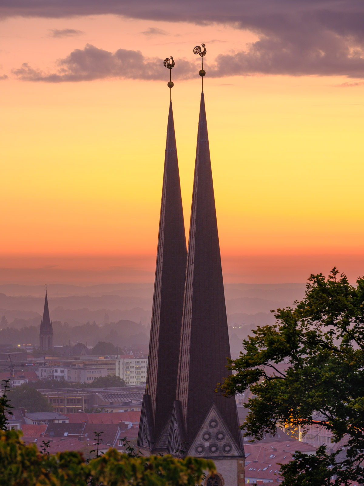 Towers of the 'Marienkirche'. Dawn over Bielefeld city center in September 2021 (Germany).