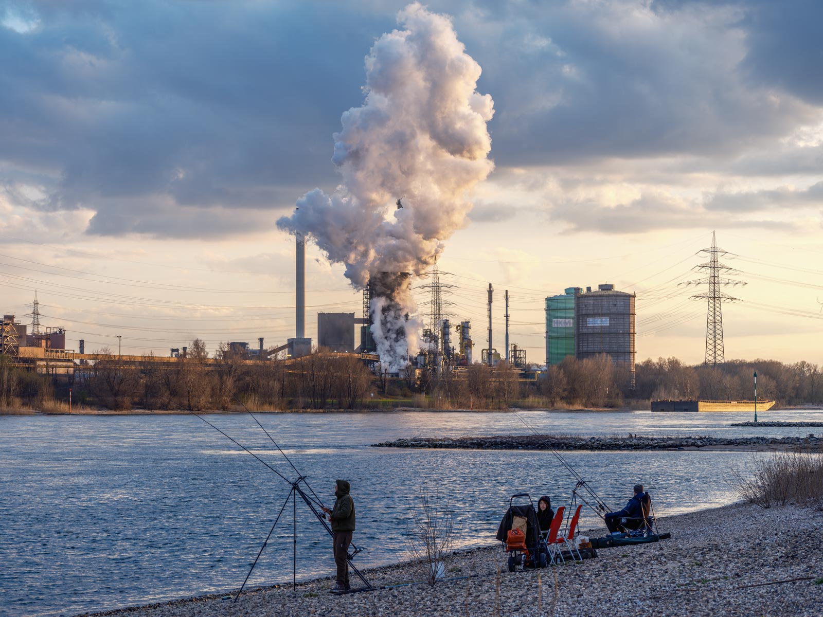 Anglers on the Rhine in Duisburg-Rheinhausen opposite the Krupp Mannesmann steelworks in March 2021 (Germany).